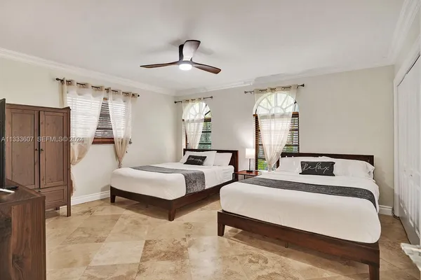 a bedroom with a bed couch and window