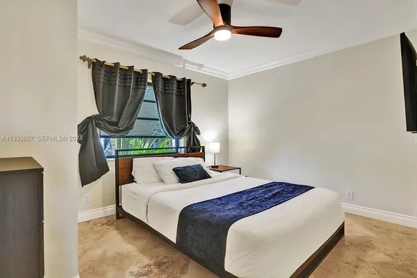 a bedroom with a bed and a mirror