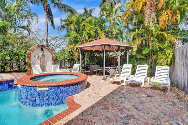 a patio with a table and chairs under an umbrella