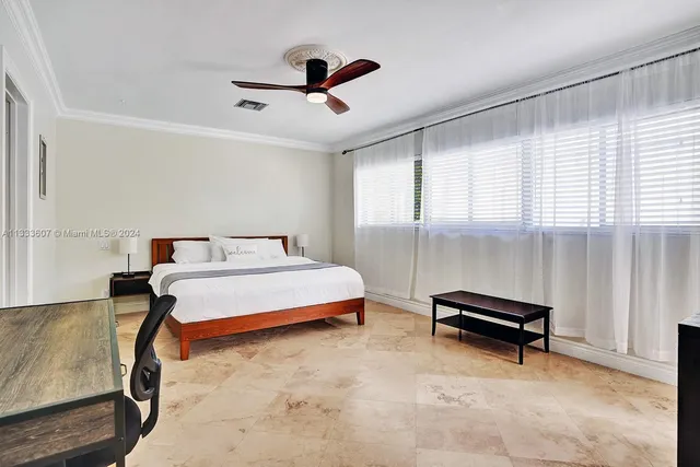 a bedroom with furniture and a window