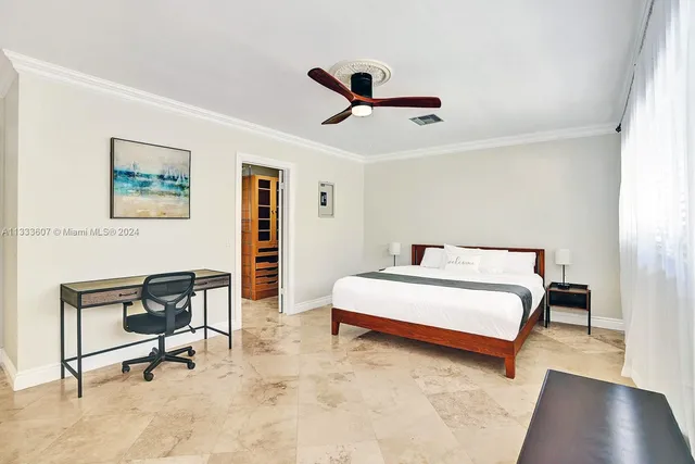 a bedroom with a bed and a desk