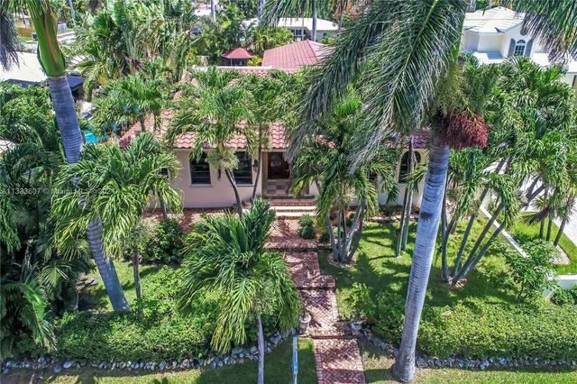 an aerial view of a house with yard