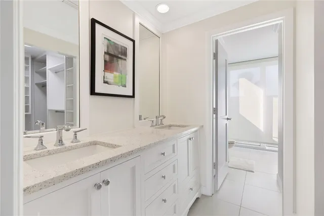 a bathroom with a double vanity sink and a mirror