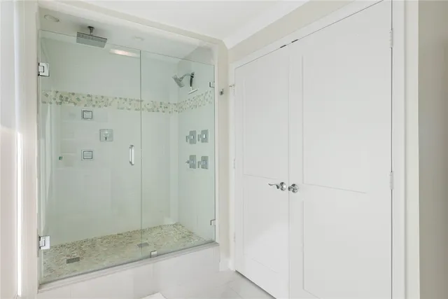 a bathroom with a glass shower door