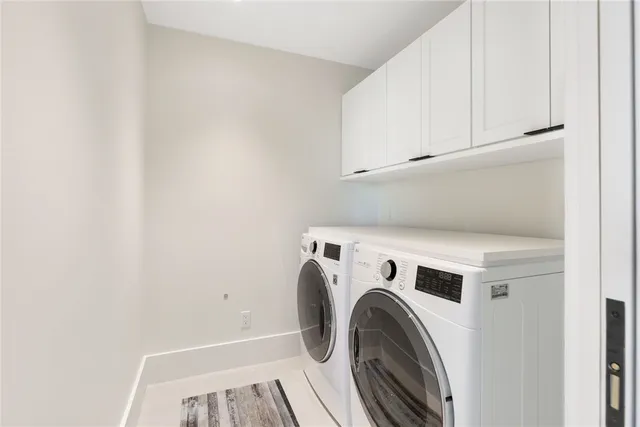 a view of washer and dryer with kitchen in the background