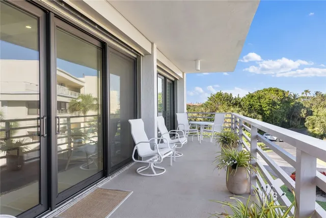 a view of balcony with chairs and potted plants