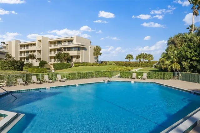 a view of a swimming pool with an outdoor space and seating area