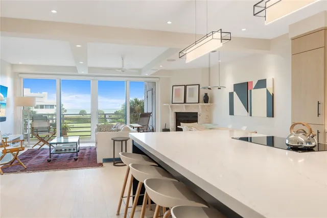 a large white kitchen with a large window