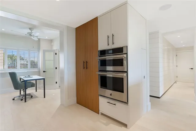 a room with table chair and refrigerator