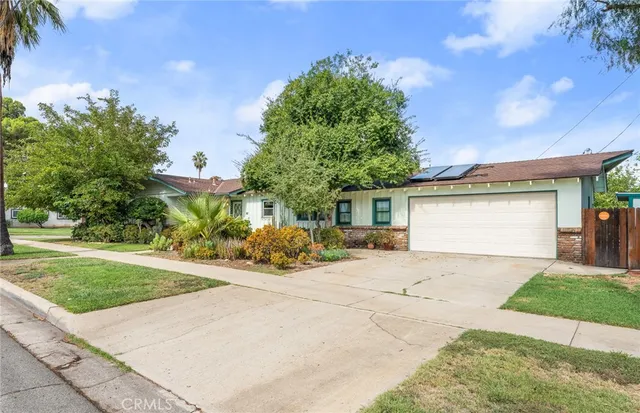 a view of a house with a yard and garage