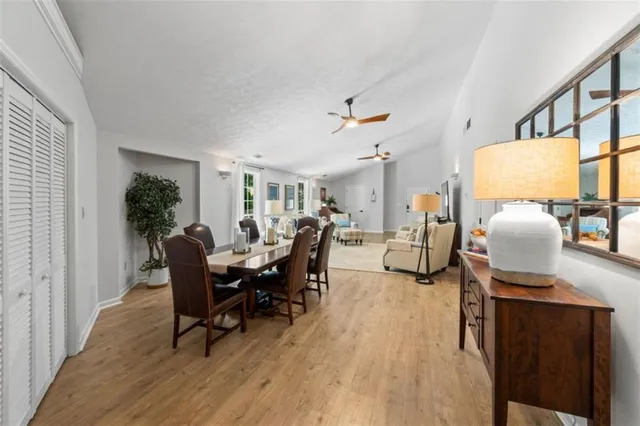 a living room with furniture dining table and a potted plant