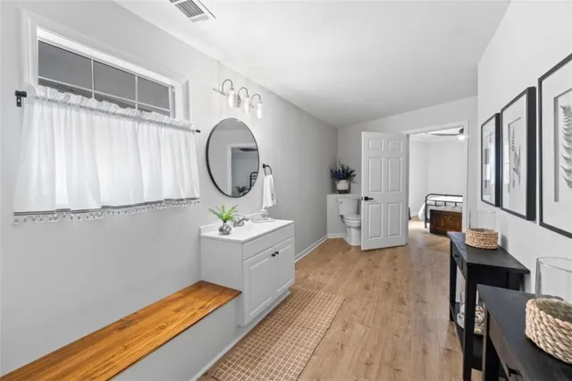 a room with bed mirror and a window