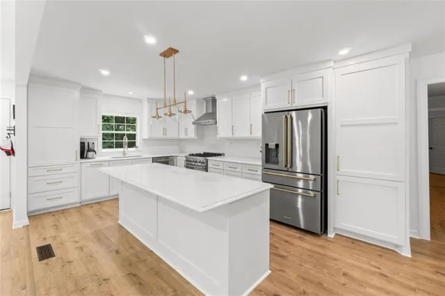 a kitchen with refrigerator cabinets and wooden floor