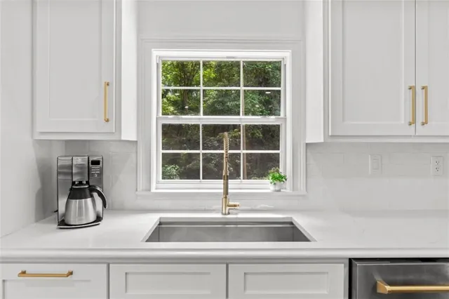 a stove top oven sitting inside of a kitchen