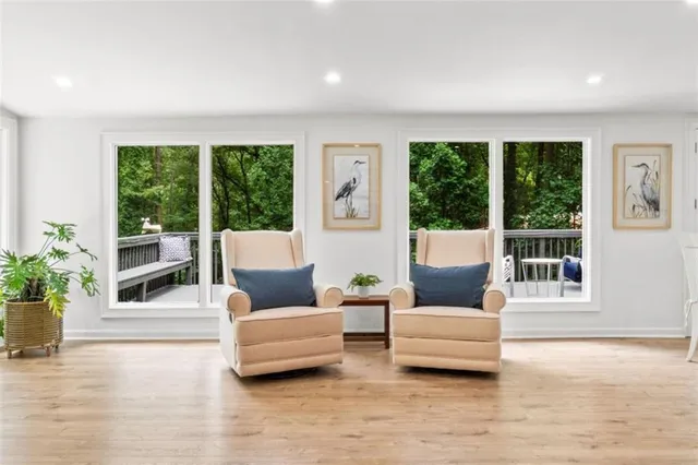 a view of a garden with plants and large trees
