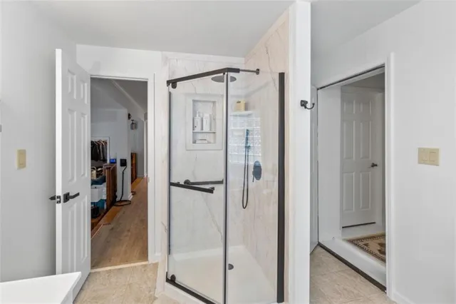 a view of house with wooden deck and furniture