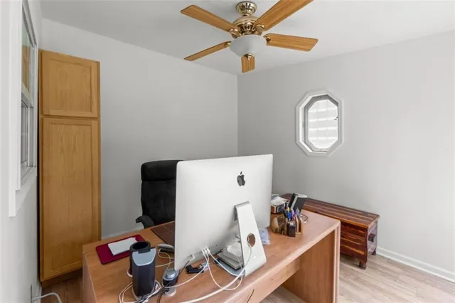 an aerial view of a house with balcony and trees al around