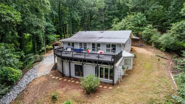a backyard of a house with a yard and large trees