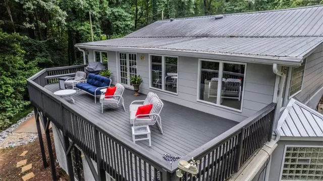an aerial view of a house with a yard and lake view