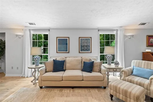 a living room with furniture and a large window