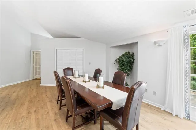 a view of a dining room with furniture and window