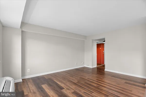 a view of an empty room and wooden floor