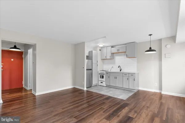 a large kitchen with a wooden floor and a stove top oven