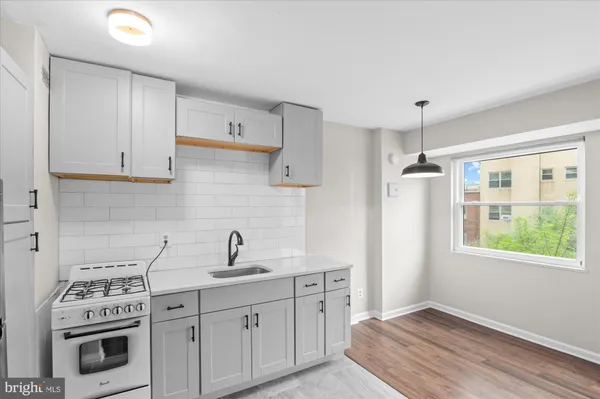 a kitchen with stainless steel appliances a refrigerator sink and stove