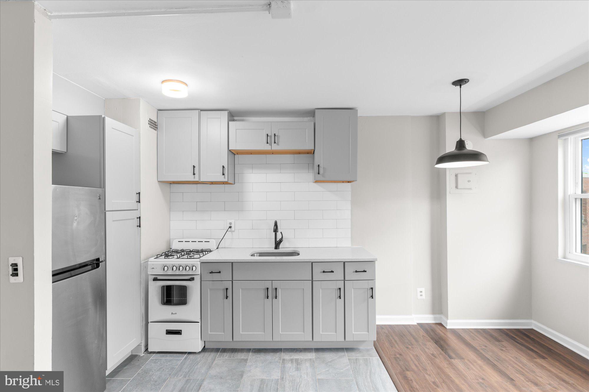 1801 Clydesdale Place Northwest, Unit 505 Washington, DC 20009 - Photo 8 of 21 a kitchen with stainless steel appliances a refrigerator sink and stove