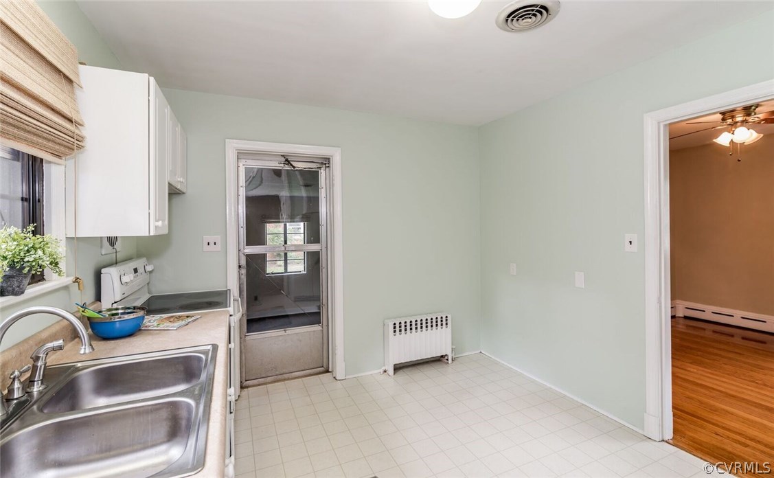 6008 Brookfield Road Richmond, VA 23227 - Photo 17 of 28 a kitchen with a sink and a refrigerator