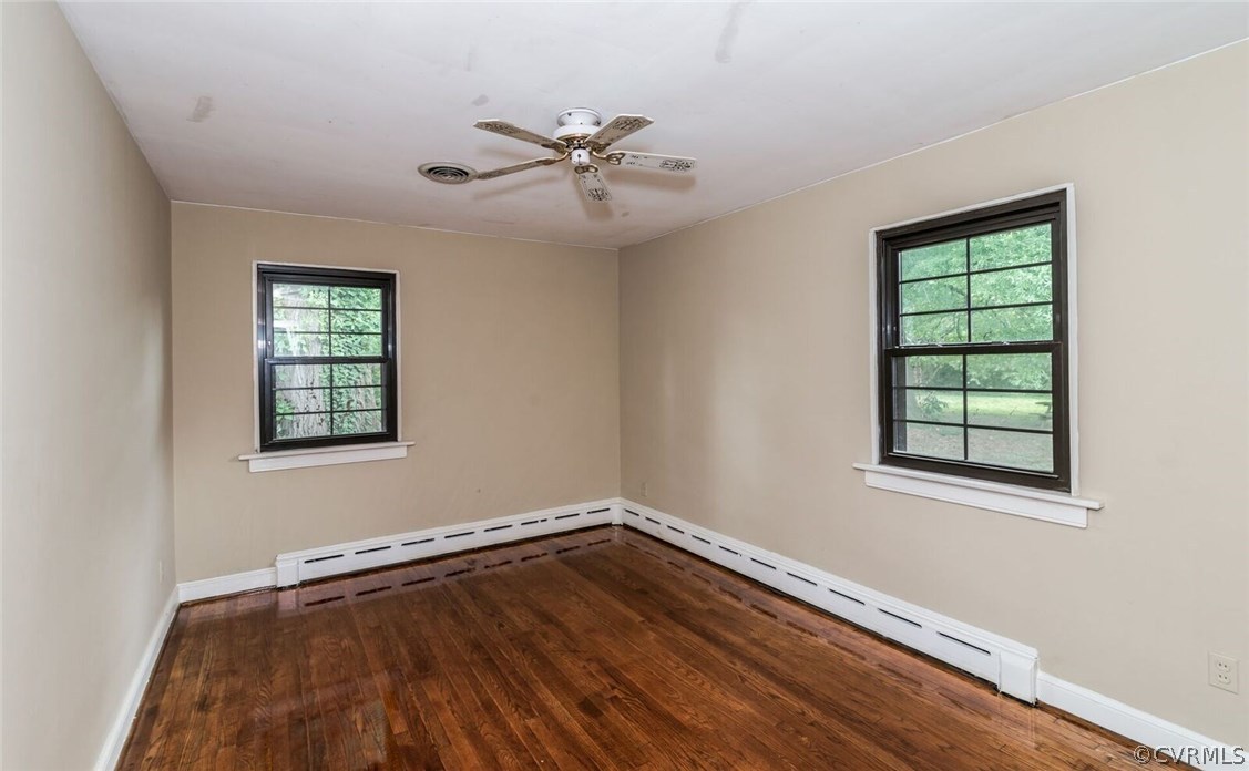 6008 Brookfield Road Richmond, VA 23227 - Photo 24 of 28 a view of an empty room with wooden floor and window