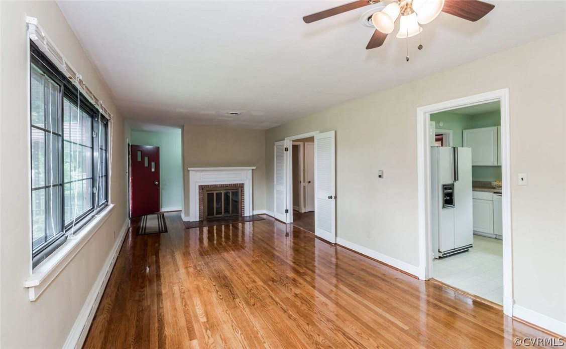6008 Brookfield Road Richmond, VA 23227 - Photo 8 of 28 a view of a livingroom with wooden floor and a ceiling fan