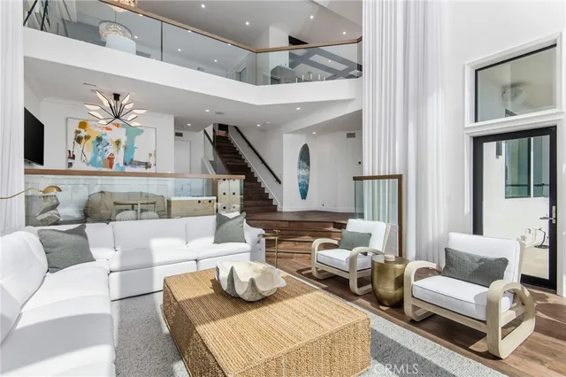 a living room with furniture and a painting on the wall