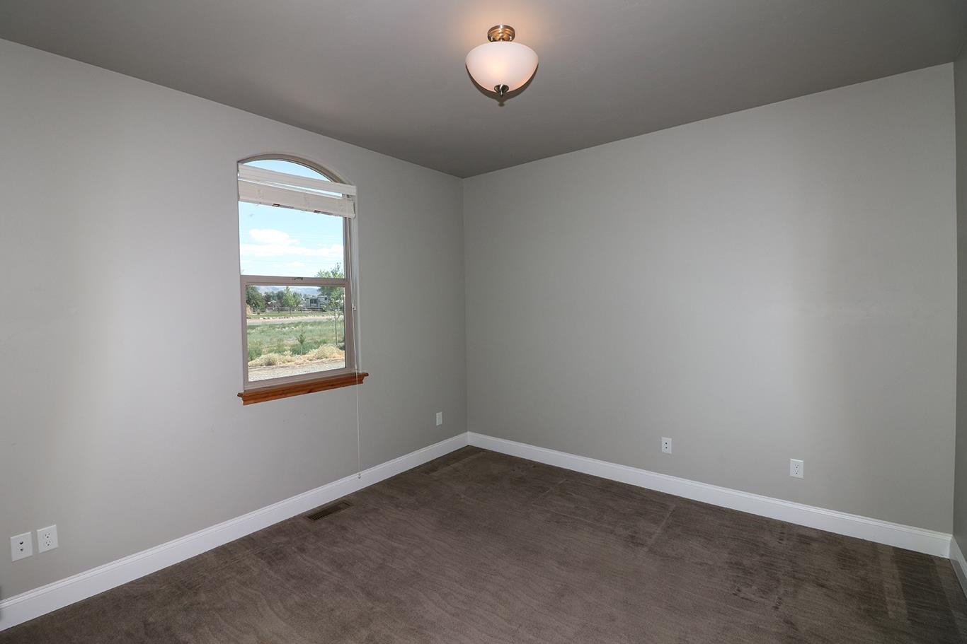1983 J Road Fruita, CO 81521 - Photo 21 of 42 an empty room with a window