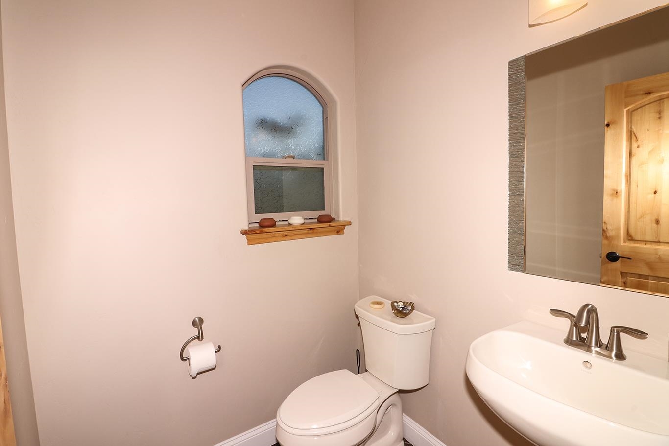 1983 J Road Fruita, CO 81521 - Photo 23 of 42 a bathroom with a toilet a sink and mirror