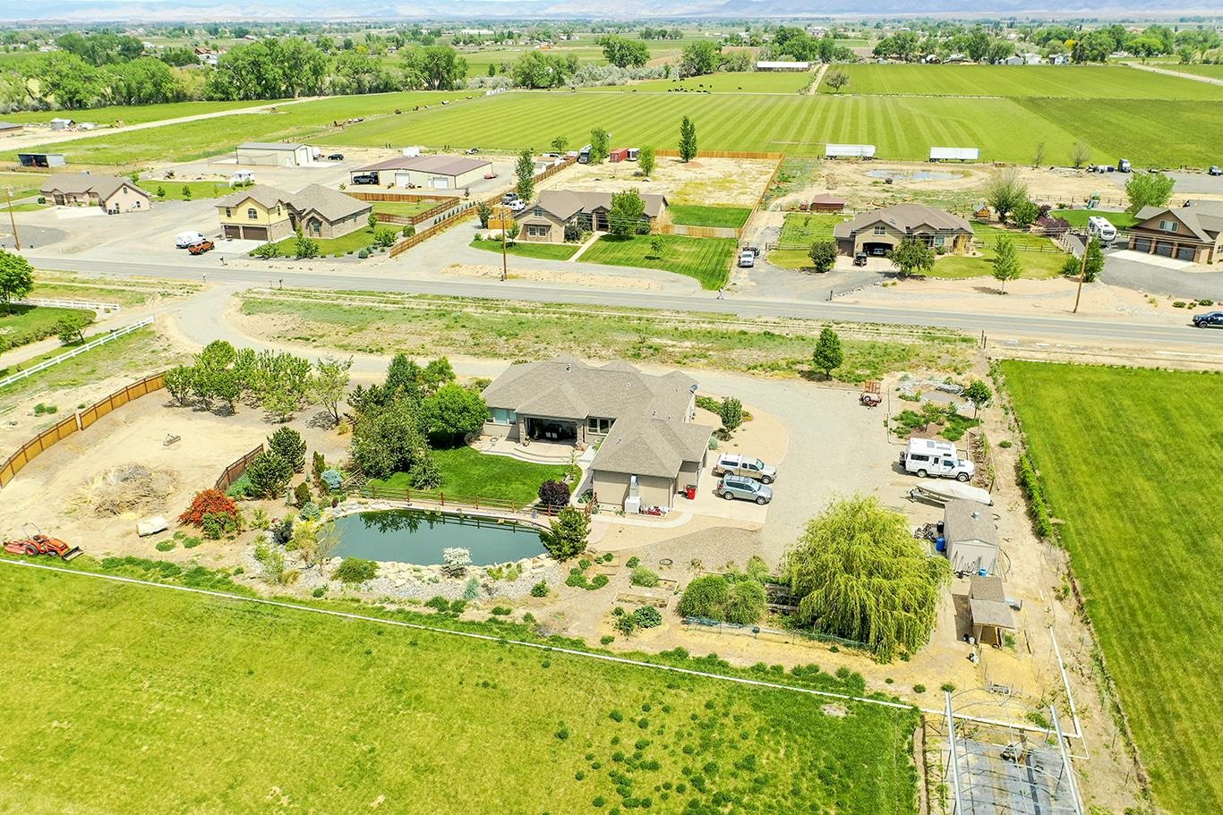 1983 J Road Fruita, CO 81521 - Photo 40 of 42 a view of a swimming pool with a yard and lake view