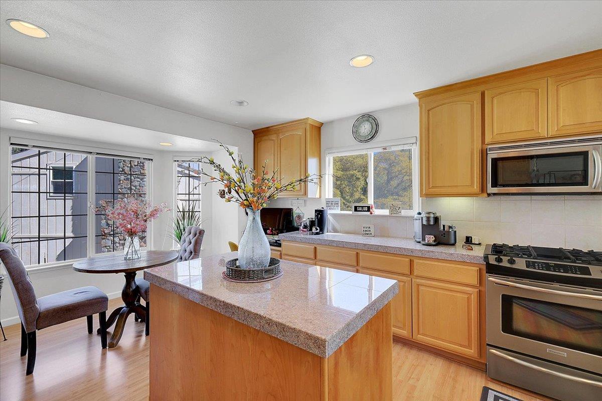16153 Janet Way Grass Valley, CA 95949 - Photo 11 of 38 a kitchen with stainless steel appliances a stove a sink a microwave a dining table and chairs