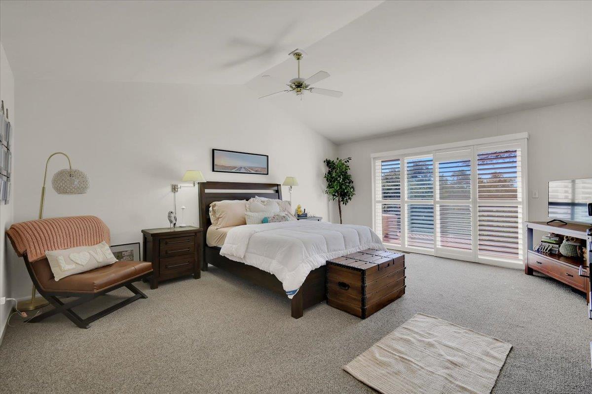 16153 Janet Way Grass Valley, CA 95949 - Photo 16 of 38 a spacious bedroom with a bed a couch and a window