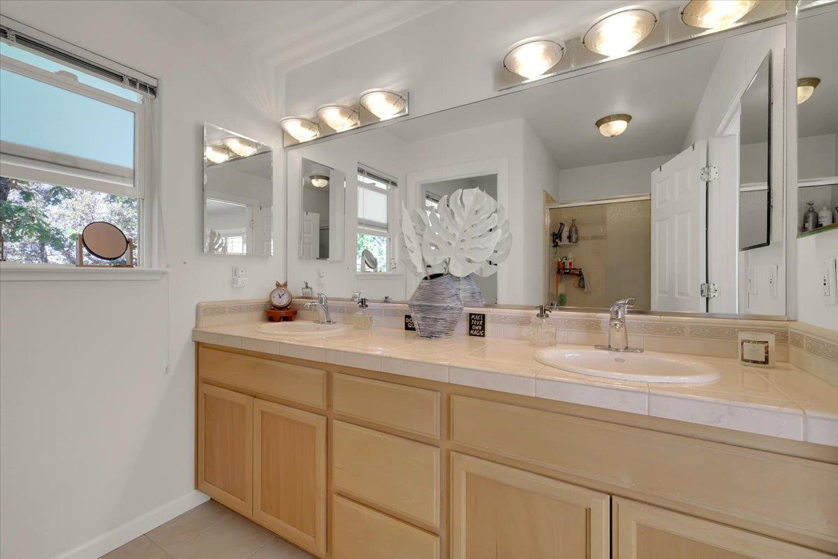 16153 Janet Way Grass Valley, CA 95949 - Photo 19 of 38 a bathroom with a double vanity sink and a mirror