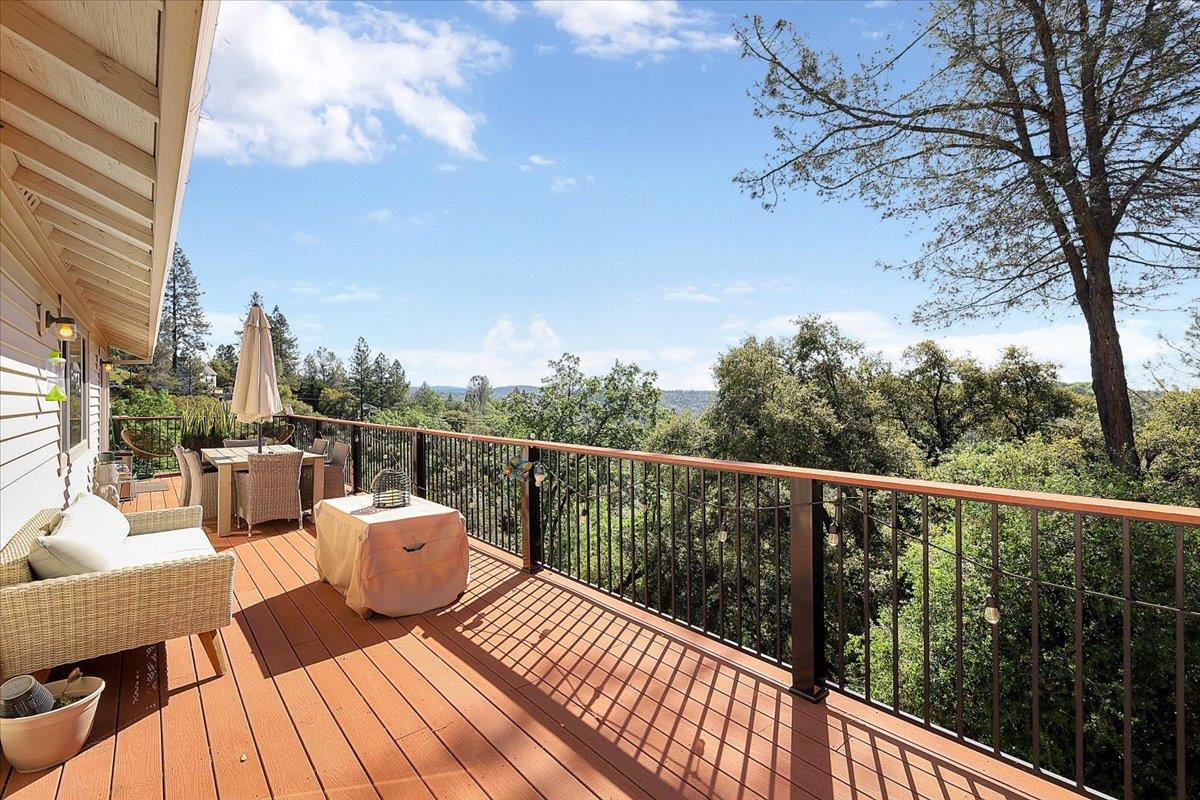 16153 Janet Way Grass Valley, CA 95949 - Photo 28 of 38 a view of a balcony with table and chairs and wooden fence