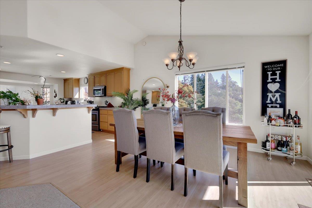 16153 Janet Way Grass Valley, CA 95949 - Photo 9 of 38 a view of a dining room and livingroom with furniture wooden floor a chandelier