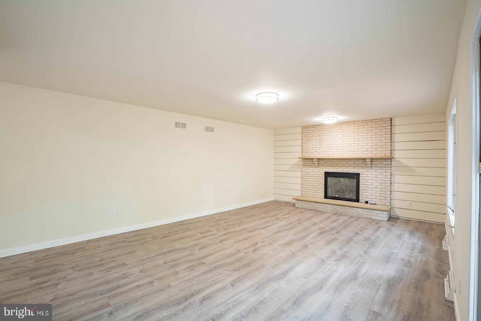 491 Kings Road Yardley, PA 19067 - Photo 21 of 52 a view of empty room with wooden floor and fireplace