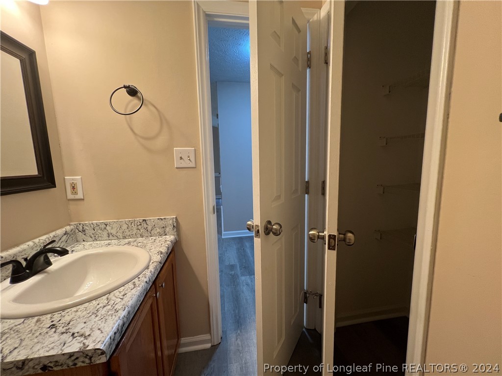 308 Kernstown Road Raeford, NC 28376 - Photo 11 of 15 a bathroom with a granite countertop sink two mirror and shower