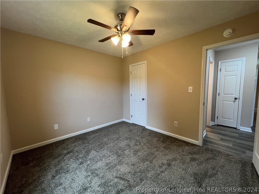 308 Kernstown Road Raeford, NC 28376 - Photo 12 of 15 an empty room with a ceiling fan and a window