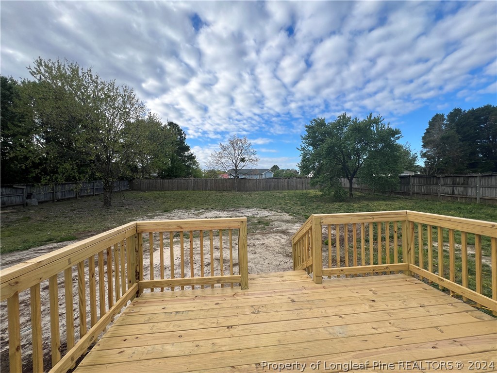 308 Kernstown Road Raeford, NC 28376 - Photo 14 of 15 a view of wooden deck and lake with trees in the background