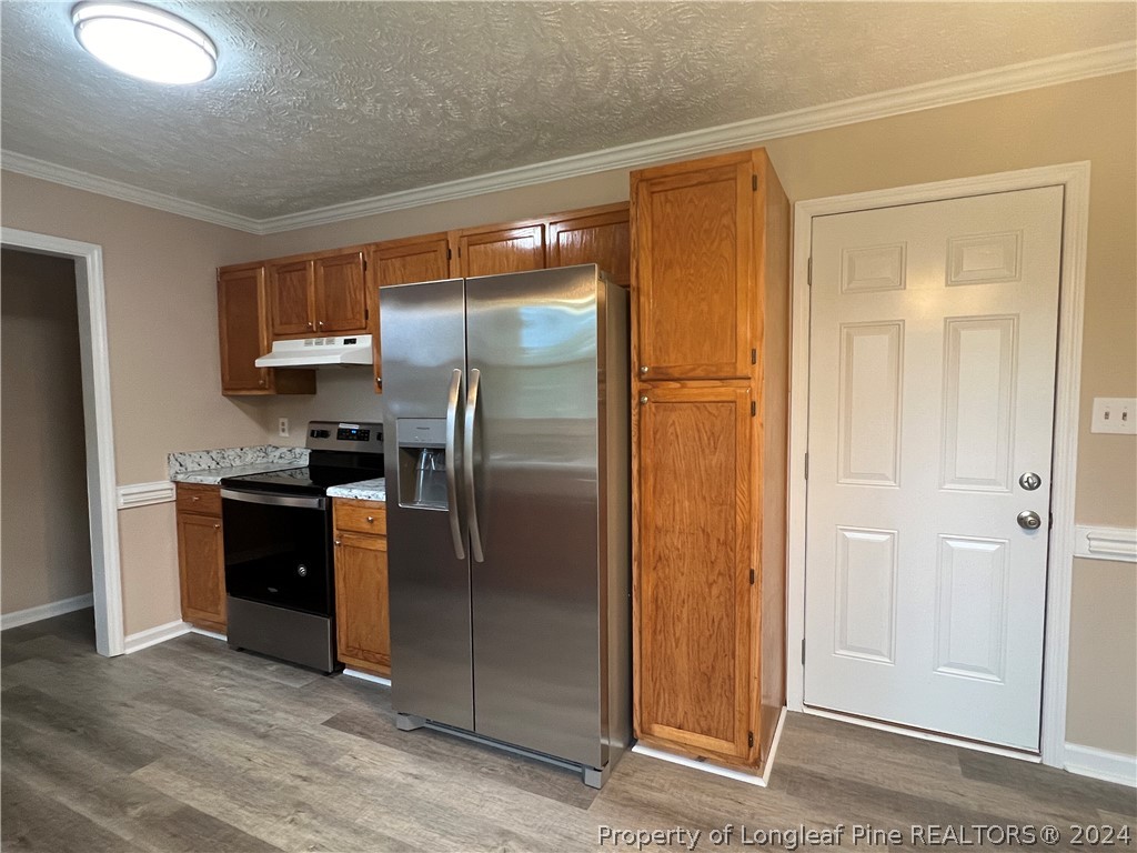 308 Kernstown Road Raeford, NC 28376 - Photo 5 of 15 a kitchen with stainless steel appliances granite countertop a refrigerator and a sink