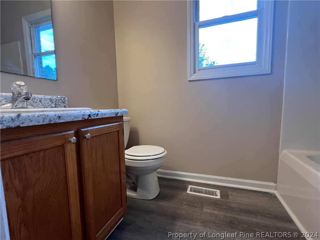 308 Kernstown Road Raeford, NC 28376 - Photo 9 of 15 a bathroom with a granite countertop toilet and a sink