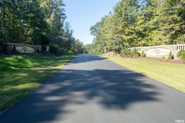a view of yard with swimming pool and trees in the background
