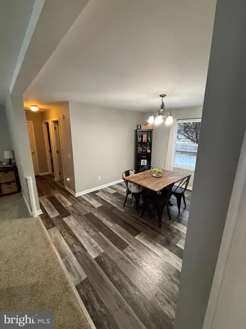 a living room with furniture and a mirror