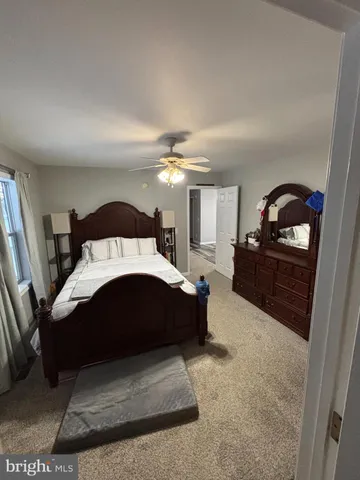 a spacious bedroom with a large bed and a dresser
